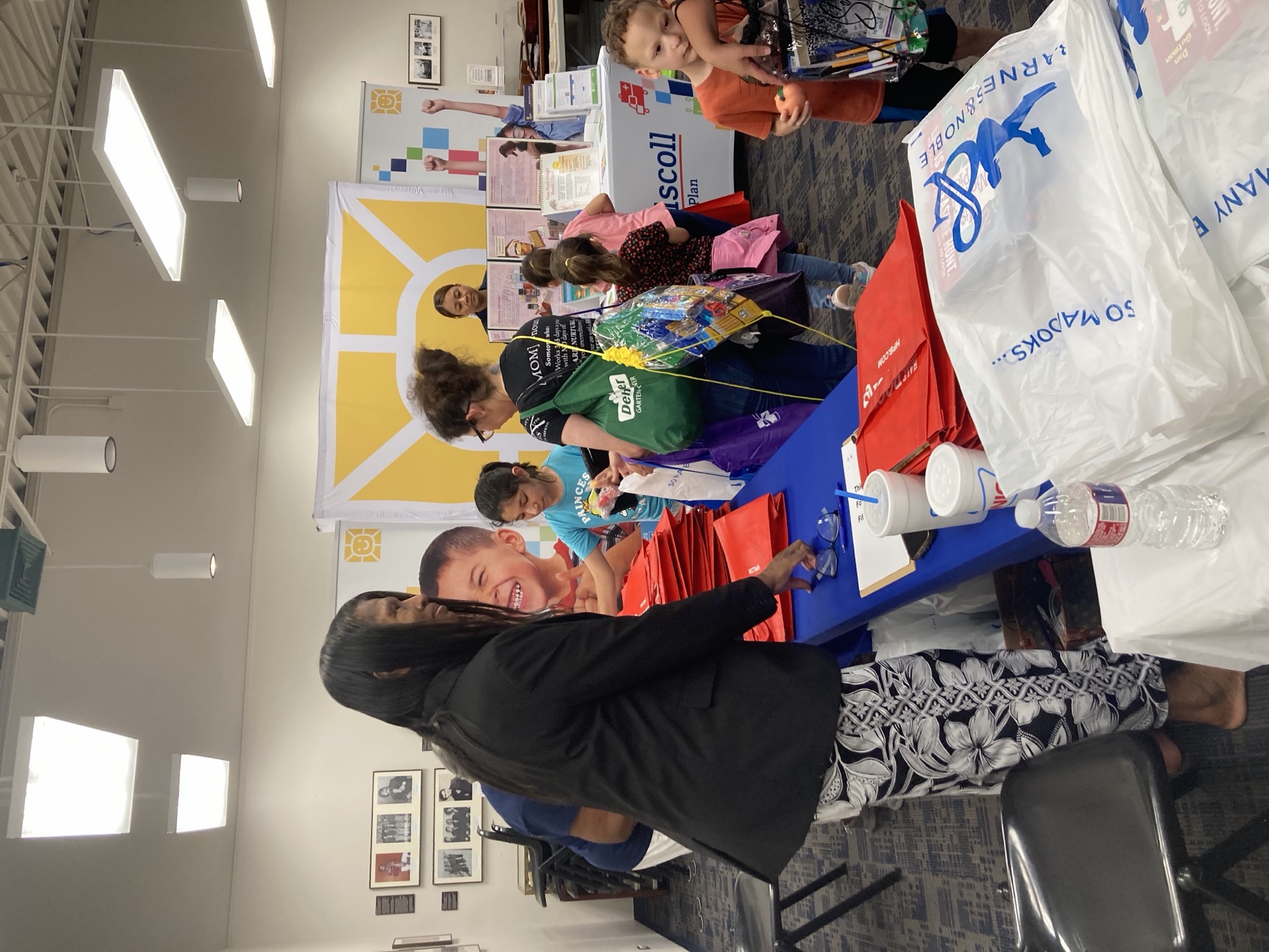 Families and volunteers connecting at a community resource table with NAACP branding