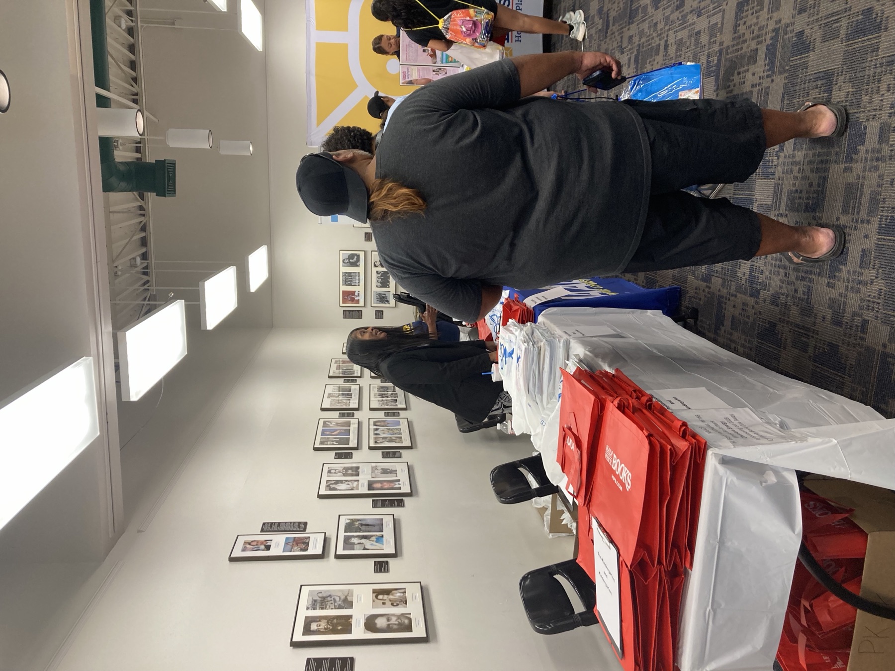 Families visiting a community resource table in a cultural exhibit space