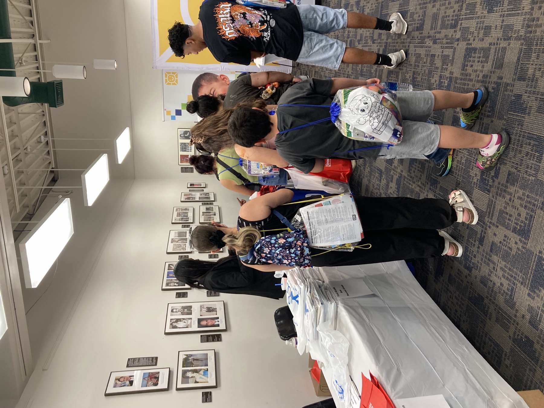 Families and children gathered around the NAACP community table